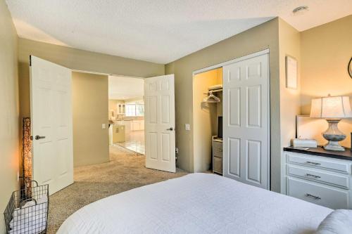 a bedroom with a white bed and a hallway at Bright Indio Home with Pool about 2 Mi to Coachella in Indio