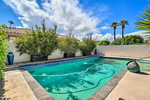 a swimming pool with turquoise water in a house at Bright Indio Home with Pool about 2 Mi to Coachella in Indio