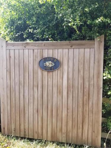 a wooden fence with a sign on it at The Lodge at Pickford House NEC and B'Ham Airport, Coventry in Coventry
