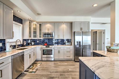 a kitchen with white cabinets and stainless steel appliances at Waterfront Sanctuary with Panoramic Bay Views! in Pierces Point