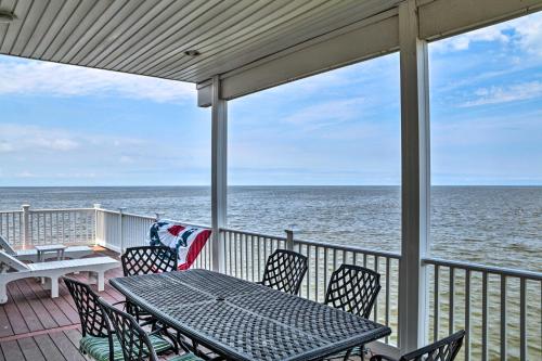 a porch with a table and chairs and the ocean at Waterfront Sanctuary with Panoramic Bay Views! in Pierces Point