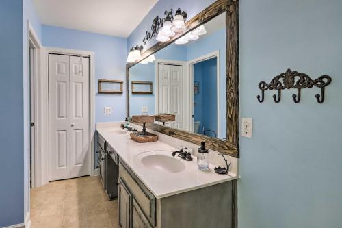 a bathroom with a sink and a mirror at Idyllic Hawkinsville Retreat Large Fire Pit! in Hawkinsville
