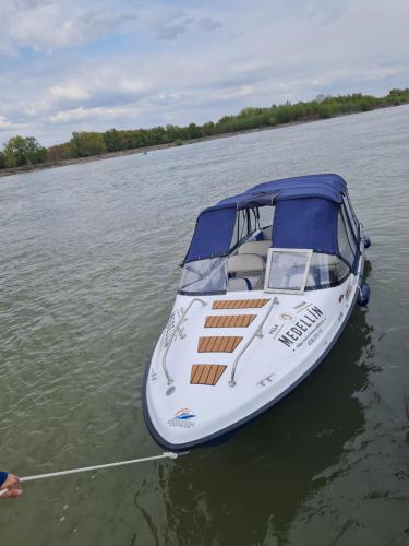 a boat is tied up on the water at pensiunea medellin in Tulcea