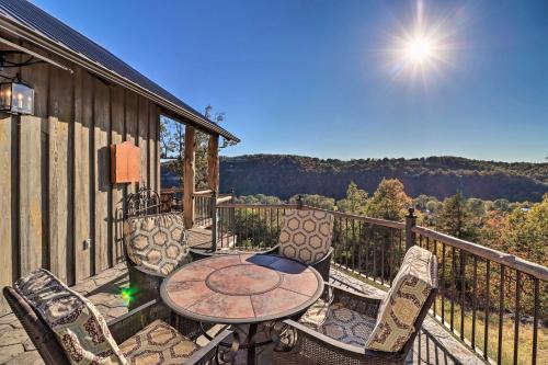 a patio with a table and chairs on a balcony at Mountain View Hideaway with Outdoor Fireplace! in Mountain View