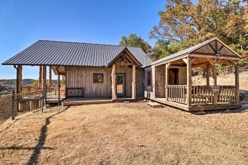 a cabin with a gambrel roof and a porch at Mountain View Hideaway with Outdoor Fireplace! in Mountain View