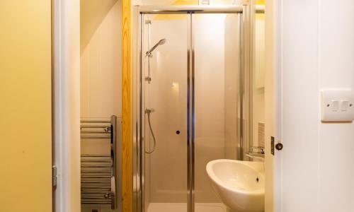 a bathroom with a shower and a sink at Willow Tree Barn Pod in Kendal