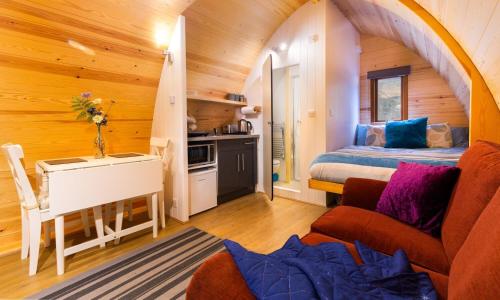a bedroom with a bed and a desk in a room at Willow Tree Barn Pod in Kendal