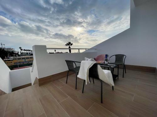 a balcony with a table and chairs and a view of the ocean at Malibu Park 2115 - Ocean View in Adeje