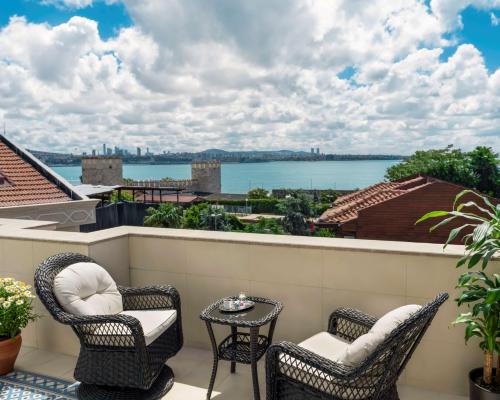 a balcony with chairs and a table and a view of the water at Royan Hotel Hagia Sophia, a member of Radisson Individuals in Istanbul