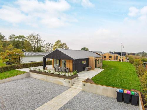 a contemporary house with a black roof at Luxury Seaside Retreat - By Traum Ferienwohnungen in Haderslev