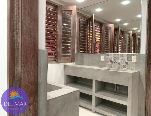 a wine cellar with two sinks and wooden cabinets at Pousada ResDelMar in Baía Formosa