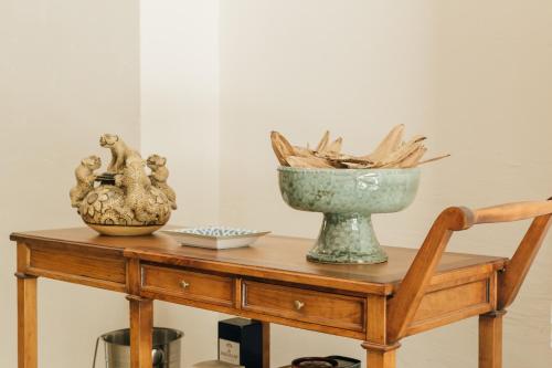 a table with two vases and a bowl on it at Orchid House San Miguel de Allende in San Miguel de Allende