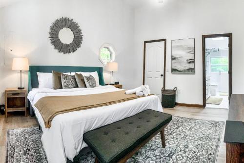 a bedroom with a large bed and a mirror at Tree and Easy in Tobyhanna