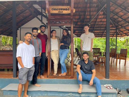 a group of people posing for a picture in a house at Crossroads Hostel 1957 in Wayanad