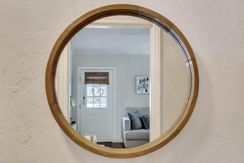a mirror on a wall with a chair and a couch at Rosé Getaway Close to Downtown Paso Robles 2 Bed/1 Bath in Paso Robles
