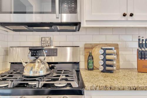 a tea kettle sitting on top of a stove in a kitchen at Rosé Getaway Close to Downtown Paso Robles 2 Bed/1 Bath in Paso Robles