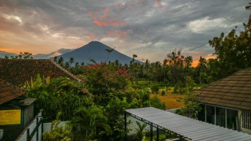 a mountain in the distance with houses and trees at BALI AMED FEEL HOME VILLA in Amed
