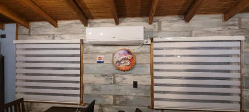 a wall with two metal doors and a air conditioner at Cabañas IBY y KIARA para 4 en Puerto Varas in Puerto Varas