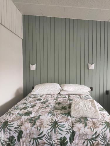 a bedroom with a bed with a floral bedspread at The Avenue in Whanganui