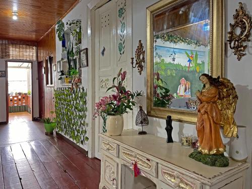 a statue of a woman on a dresser in a room at Casa Madre Tierra SRC in Santa Rosa de Cabal