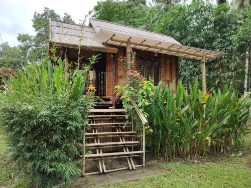 a small house with a staircase leading up to it at Kuba Bungalows in Ko Kood