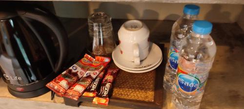 a kitchen counter with bottles of water and snacks at Kuba Bungalows in Ko Kood