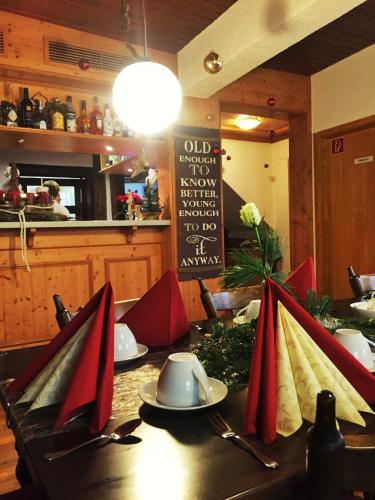 a table with red napkins on a table in a restaurant at Hotel Landgasthof Sonne in Mahlberg