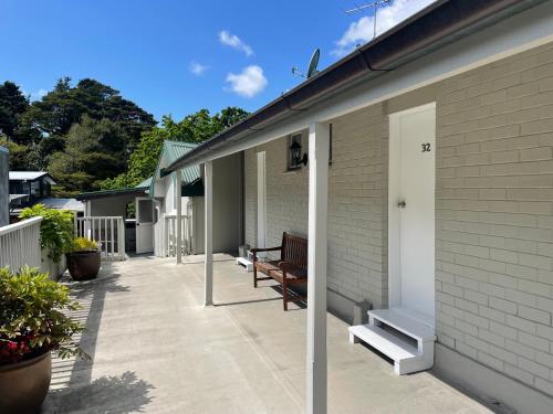 a patio with a bench on the side of a house at Bridgehouse Lodge in Warkworth