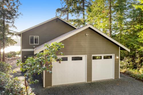 a garage with two white garage doors at Reef Point Retreat in La Conner
