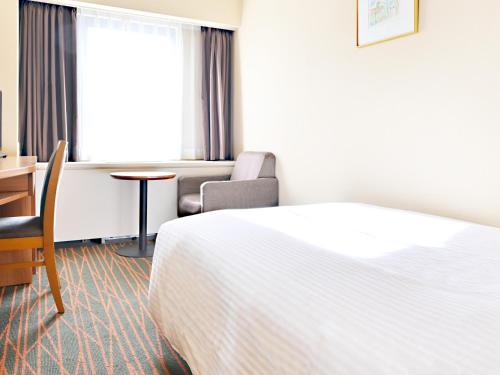 Ένα ή περισσότερα κρεβάτια σε δωμάτιο στο Hotel Abest Sapporo