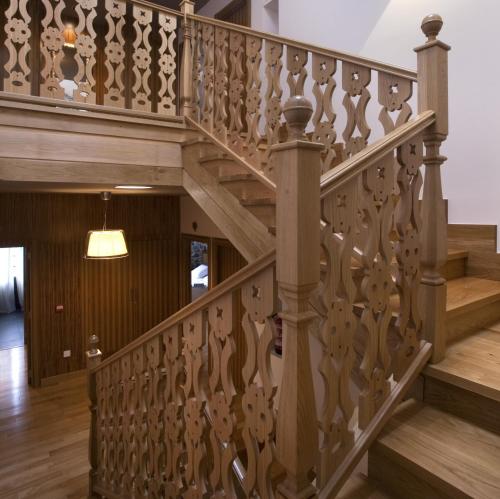 a staircase in a home with wood floors and wooden railings at Antiguo Casino Hotel in Pravia