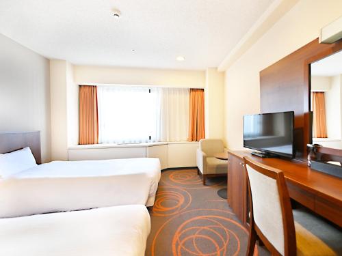 Ένα ή περισσότερα κρεβάτια σε δωμάτιο στο Hotel Abest Sapporo