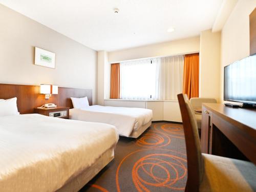 Ένα ή περισσότερα κρεβάτια σε δωμάτιο στο Hotel Abest Sapporo