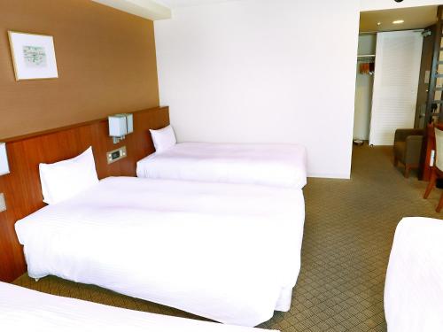Ένα ή περισσότερα κρεβάτια σε δωμάτιο στο Hotel Abest Sapporo