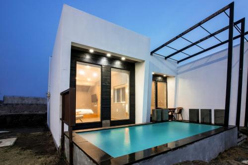 a house with a swimming pool in the backyard at Aqua Beautique Poolvilla in Jeju