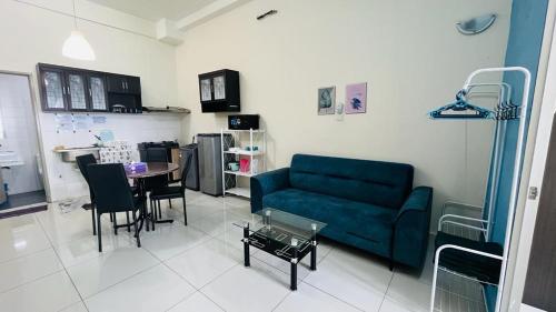 a living room with a blue couch and a table at VUE RESIDENCES Jln Pahang, KL city - 2 ROOM in Kuala Lumpur