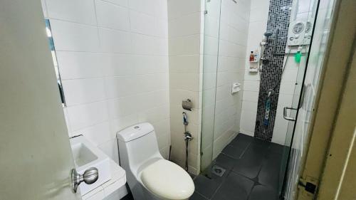 a bathroom with a toilet and a glass shower at VUE RESIDENCES Jln Pahang, KL city - 2 ROOM in Kuala Lumpur
