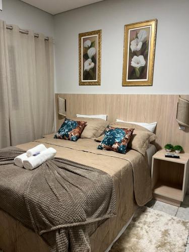 two beds in a bedroom with two pillows on them at POUSADA ACONCHEGO MT in Chapada dos Guimarães