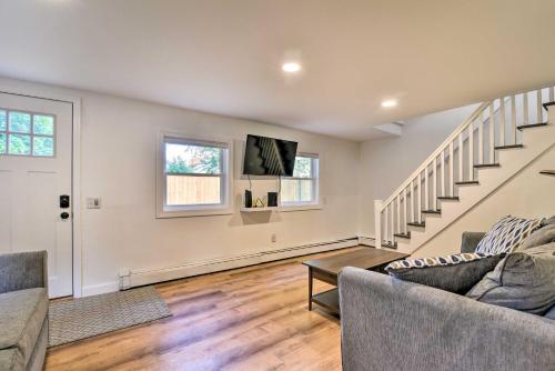 a living room with a couch and a stair case at Centrally Located Mount Pleasant Retreat! in Mount Pleasant