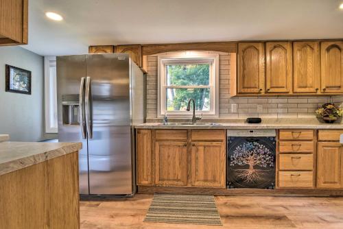 a kitchen with wooden cabinets and a stainless steel refrigerator at Centrally Located Mount Pleasant Retreat! in Mount Pleasant