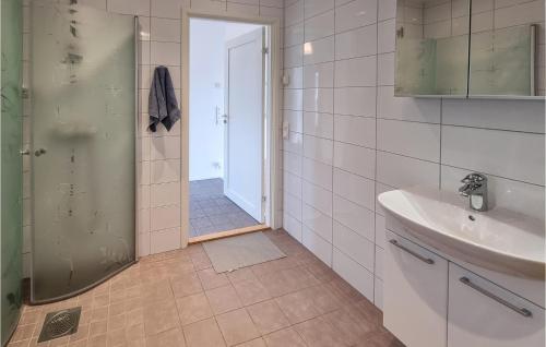 a bathroom with a sink and a toilet and a shower at Nice Home In Uddevalla With Wifi And 3 Bedrooms in Uddevalla