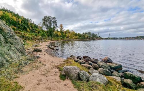 a beach with rocks on the side of a body of water at 3 Bedroom Lovely Home In Uddevalla in Uddevalla