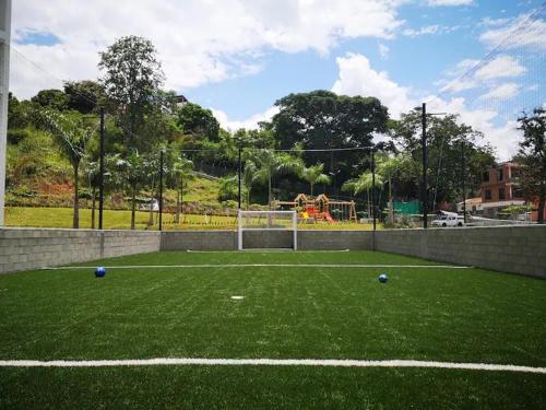 a soccer field with blue balls on the grass at Lugar encantador en Santa Fe de Antioquia in Santa Fe de Antioquia