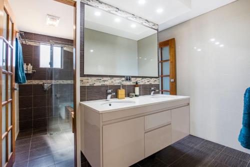 a bathroom with a sink and a shower at Enchante` - Pet Friendly - Absolute Waterfront - Fireplace in Culburra Beach
