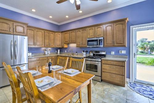 a kitchen with wooden cabinets and a wooden table at The Shell House in Titusville Pool, Golf Access in Titusville
