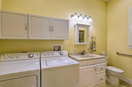 a white bathroom with a sink and a toilet at The Shell House in Titusville Pool, Golf Access in Titusville