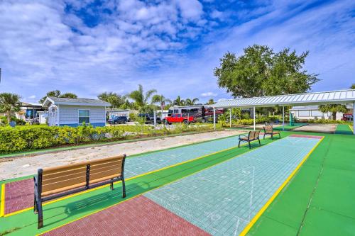 a tennis court with two benches on it at The Shell House in Titusville Pool, Golf Access in Titusville