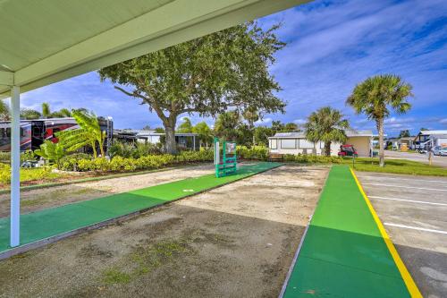 an empty parking lot with a green and yellow sidewalk at The Shell House in Titusville Pool, Golf Access in Titusville