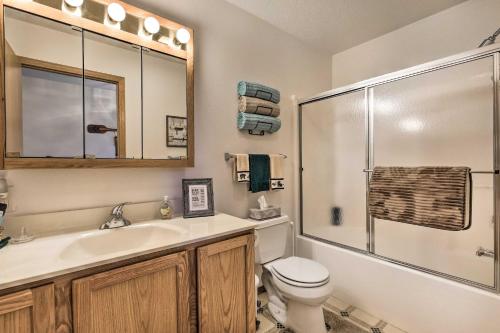 a bathroom with a sink and a toilet and a shower at Elcho Escape with Private Dock on Post Lake! in Elcho