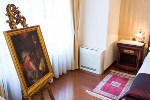 a room with a painting on the floor and a bed at Vila Paris Boutique Hotel in Bucharest